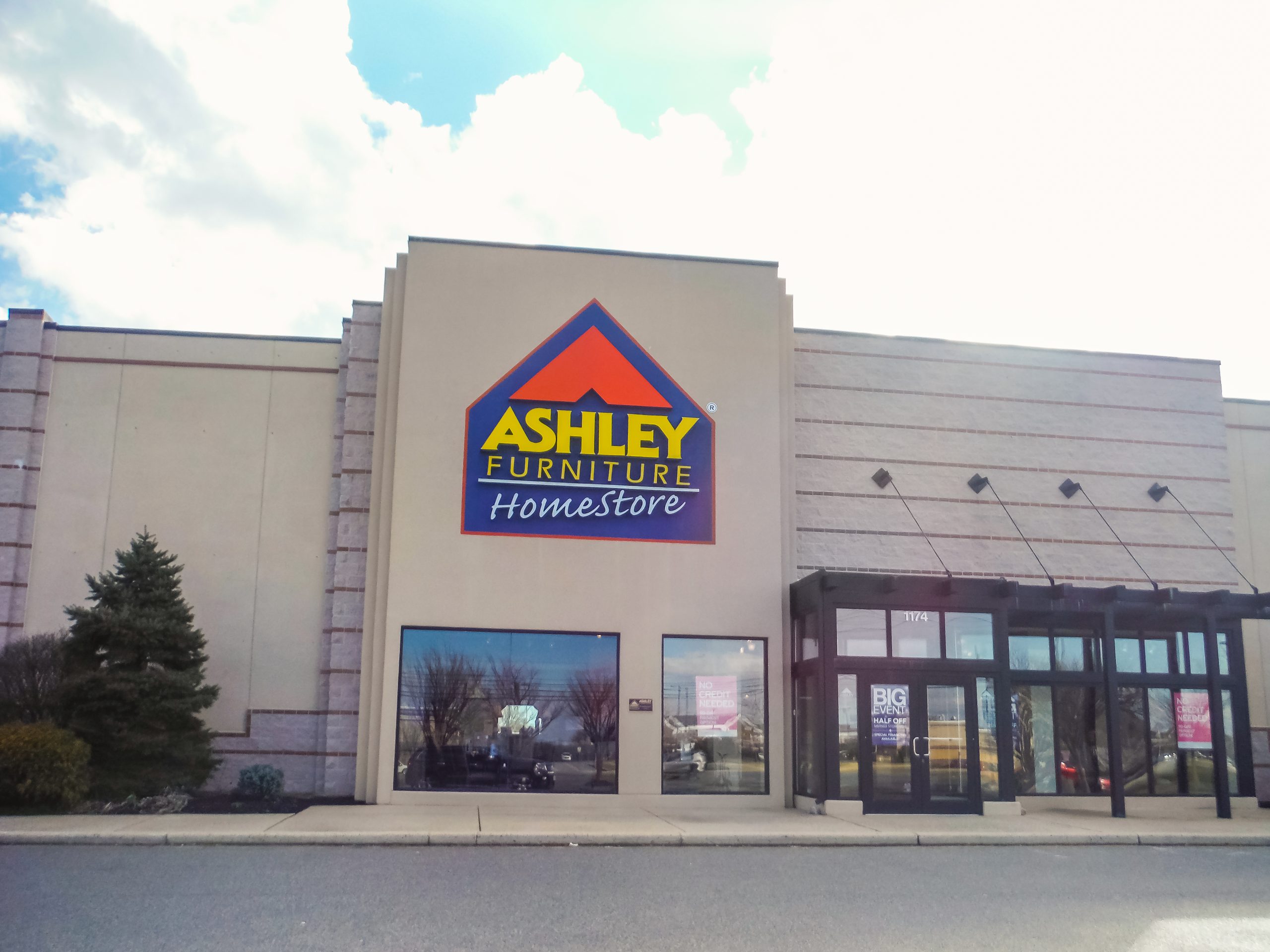 Ashley Furniture HomeStore storefront at Glendale Plaza Shopping Center with entrance doors and awnings