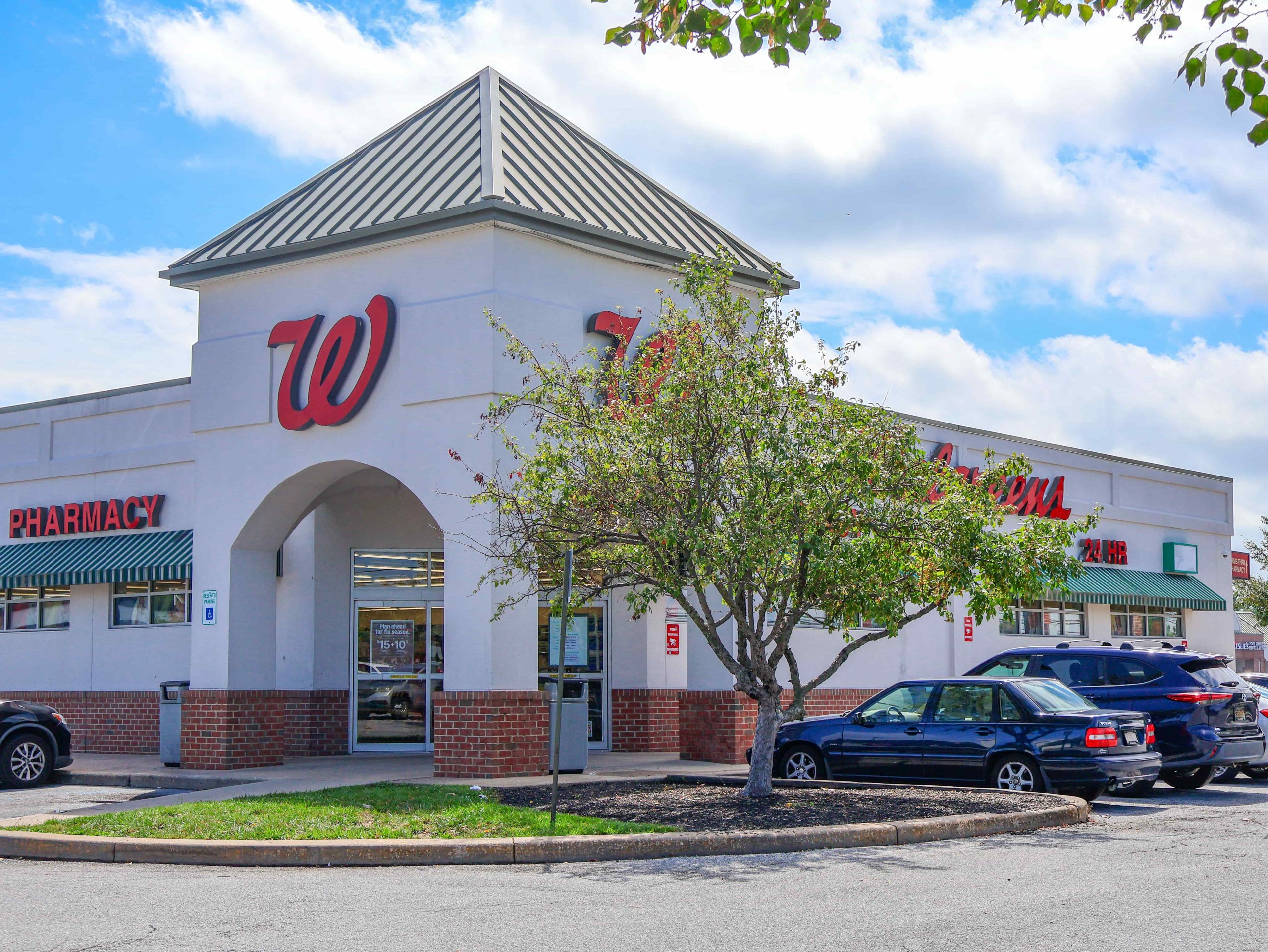 Walgreens storefront with pharmacy sign, red W logo, tower entrance, and parking lot at Glendale Plaza