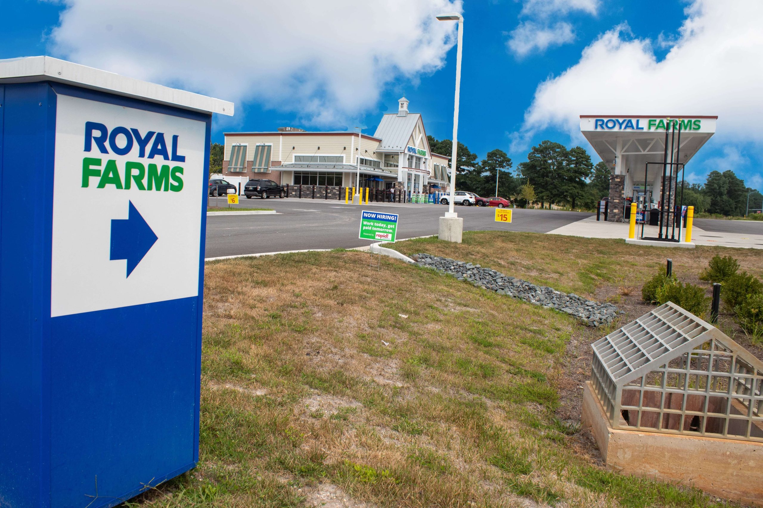 Royal Farms convenience store and fuel station with directional signage, parking, and a now hiring sign near Somerset Crossing