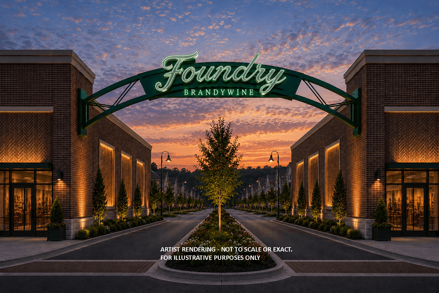 Illuminated Foundry Brandywine archway sign spans a tree-lined entrance between brick storefronts at sunset