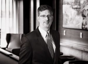 Black and white portrait of Rich Emge, who has joined Capano Management as General Counsel